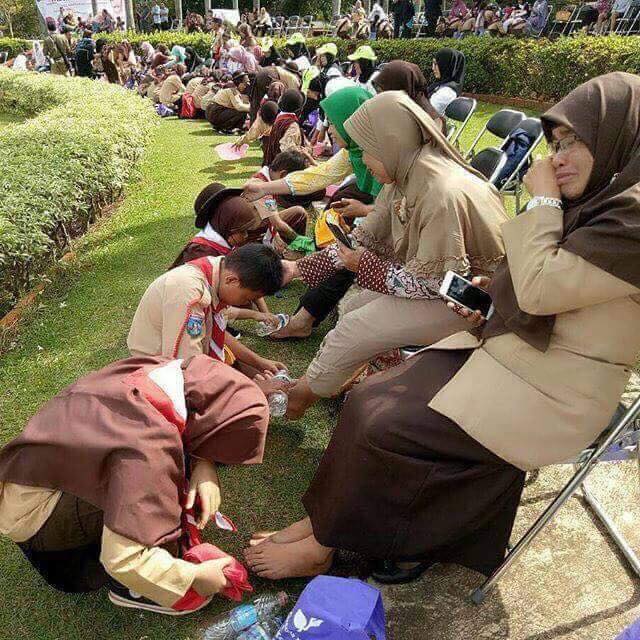 Mother’s feet washing ceremony in Indonesian School.